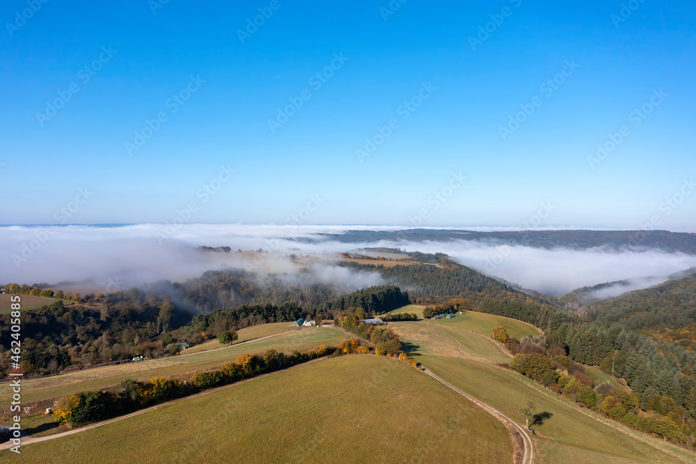Bird's-eye view of the Taunus landscape / Germany with the fog-shrouded Wisper Valley in the background Bird's-eye view of the Taunus landscape / Germany with the fog-shrouded Wisper Valley in the background