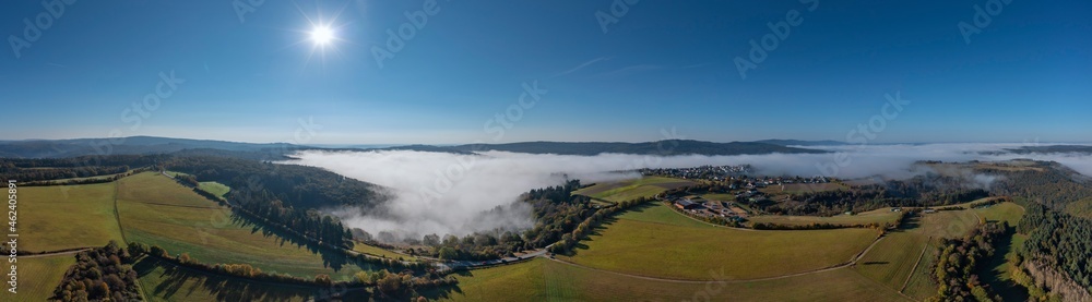 Panorama from a bird's eye view of the Taunus landscape / Germany with the fog-shrouded Wisper Valley in the background