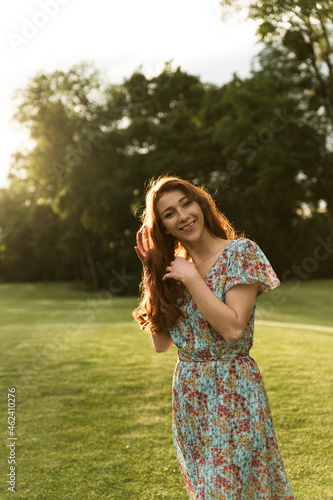 portrait of a girl with freckles and red hair. sunset. joyful girl at sunset of the day. summer dress and cheerful mood. portrait of a girl. unique appearance