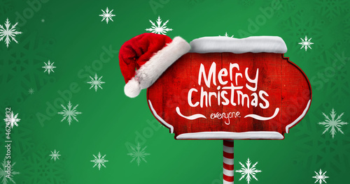 Image of falling snowflakes over wooden sign with merry christmas text photo