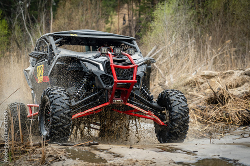 ATV/UTV/4x4 off-road vehicle in muddy water