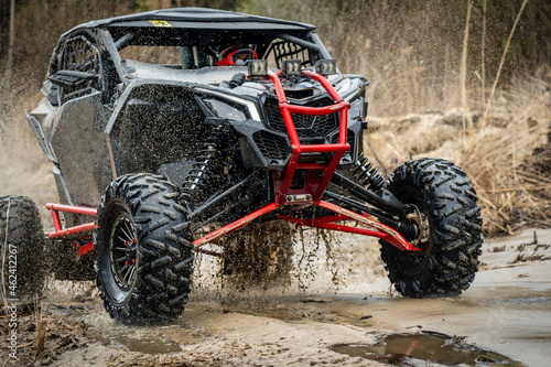 ATV/UTV/4x4 off-road vehicle in muddy water