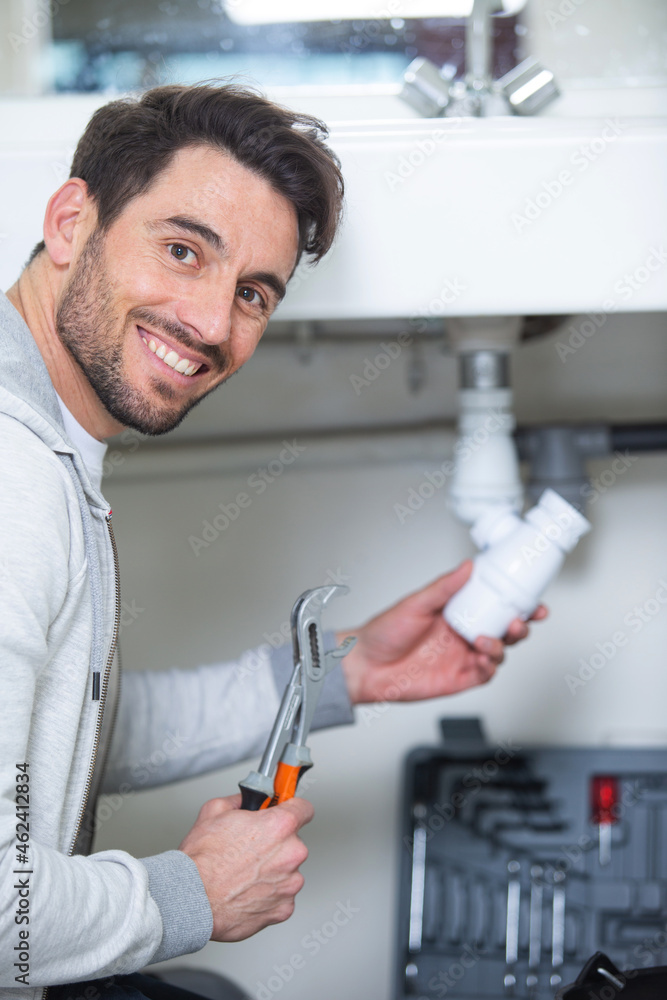 male plumber fixing sink pipe male plumber fixing sink pipe