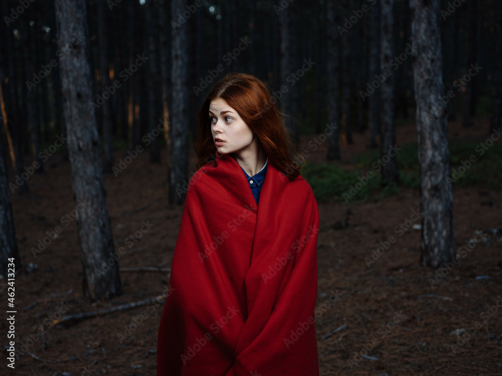 pretty red-haired woman in red plaid forest rest