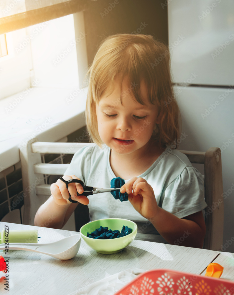 Child playing play dough. ild development concept, fine motor skills