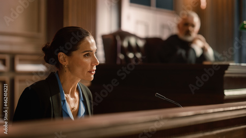 Court of Law and Justice: Portrait of Beautiful Female Victim Giving Heartfelt Testimony to Judge, Jury. Emotional Speech of Empowered Woman against Crime, Injustice, Prejudice, Corruption photo