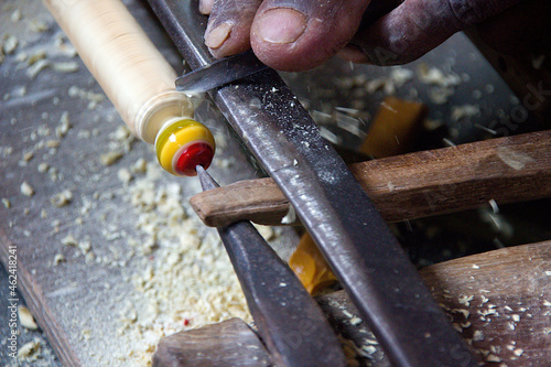 Skilled village artisan making a wooden toy at Madhu Vana near Bengaluru, Karnataka, India photo