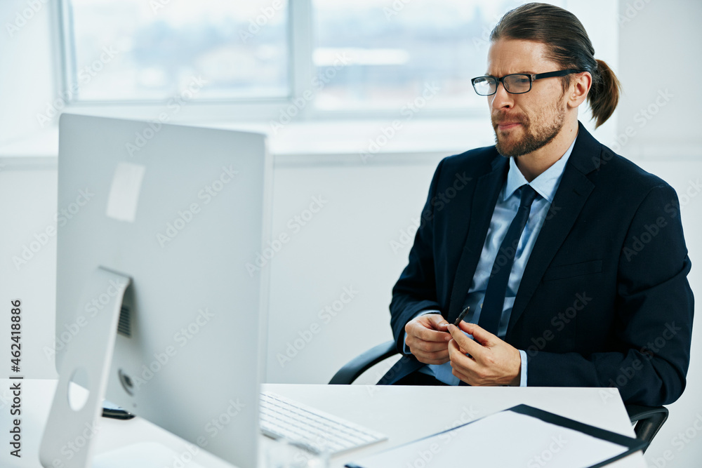 male manager at the desk with glasses work technologies male manager at the desk with glasses work technologies