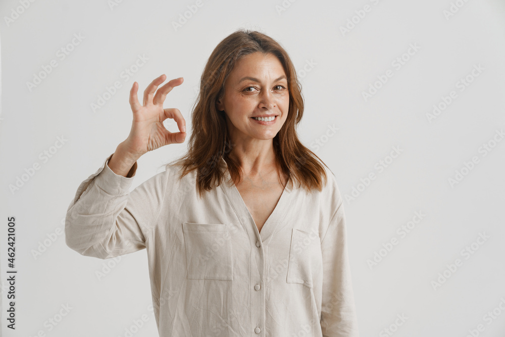 European ginger woman smiling and showing ok sign European ginger woman smiling and showing ok sign