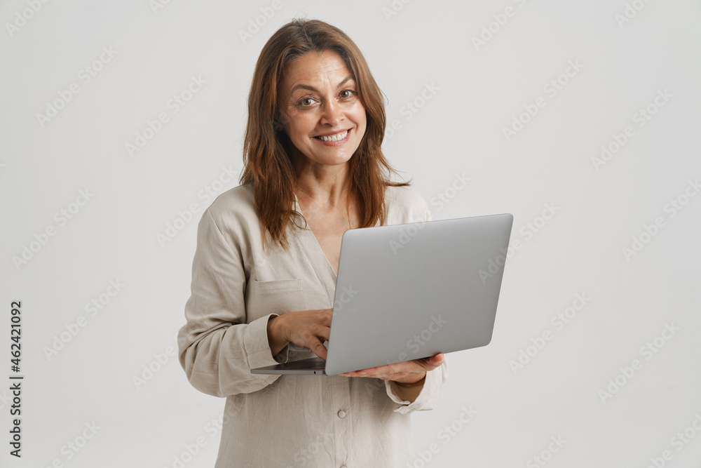 European ginger woman smiling while using laptop European ginger woman smiling while using laptop