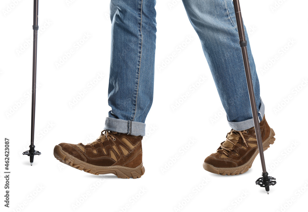 Man wearing stylish hiking boots with trekking poles on white background, closeup Man wearing stylish hiking boots with trekking poles on white background, closeup