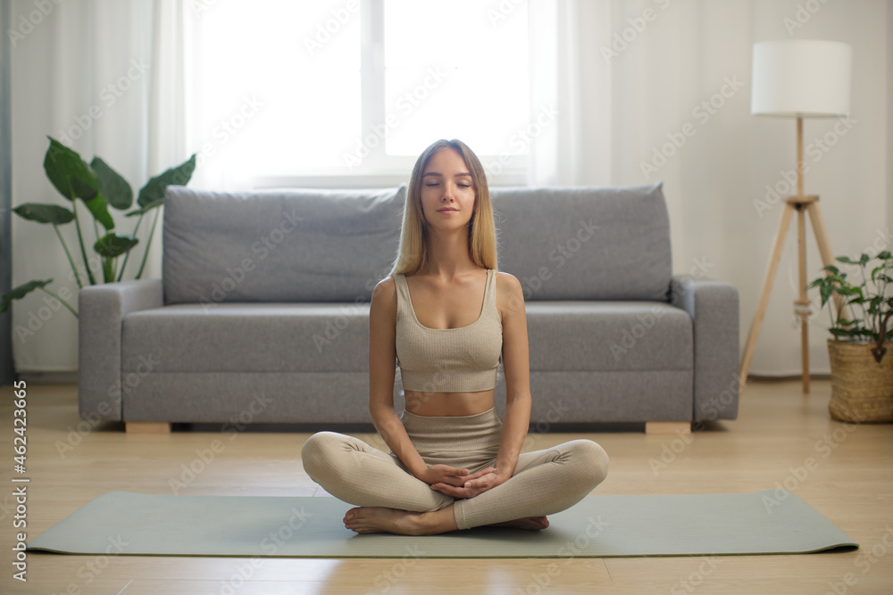 Woman in Meditation on Yoga Mat at Home Woman in Meditation on Yoga Mat at Home