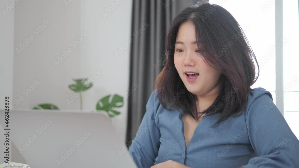 Happy excited asian woman at home with raised hands,Enjoying time, Beautiful young smiling girl working on laptop , celebrating the success business Happy excited asian woman at home with raised hands,Enjoying time, Beautiful young smiling girl working on laptop , celebrating the success business