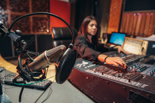 Φωτογραφία Young woman music producer working on a mixing soundboard while in her studio