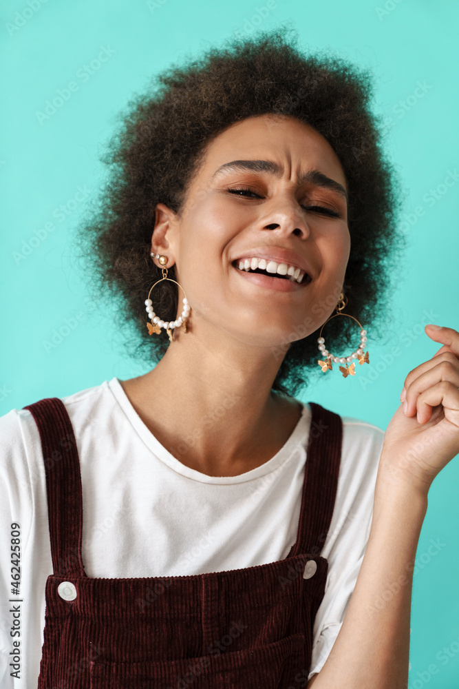 Young black woman wearing earrings laughing and looking at camera Young black woman wearing earrings laughing and looking at camera
