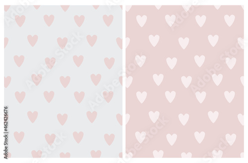 Cute Seamless Vector Pattern with Pink Irregular Hand Drawn Hearts on a Light Pink and Light Gray Background. Funny Infantile Design with Love Symbols. Romantic Repeatable Print ideal for Fabric.