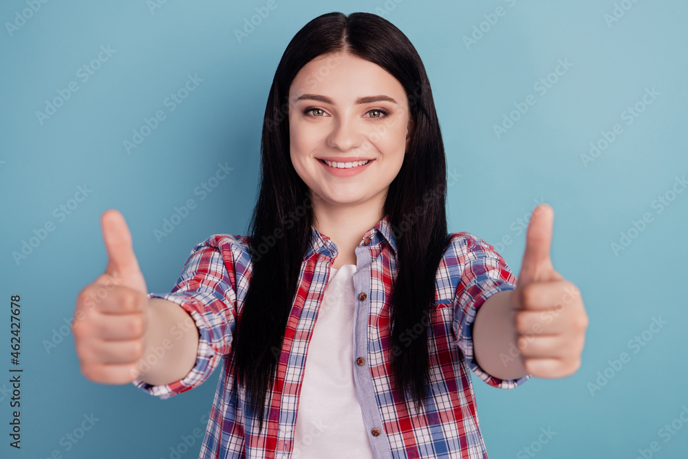 Photo of young cheerful girl show thumbs-up like fine cool advertise isolated over teal color background Photo of young cheerful girl show thumbs-up like fine cool advertise isolated over teal color background