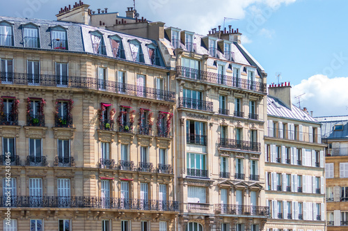 Typical architectural features of parisian buildings. Stone repetitive facade with blu zinc plates roof