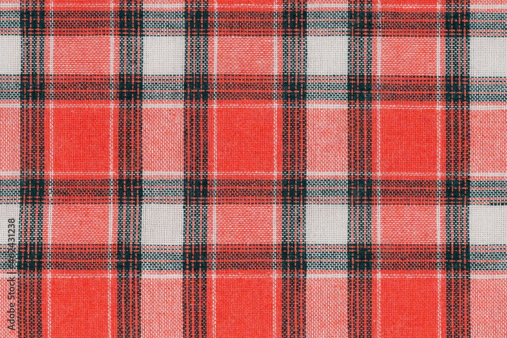 Red white tartan texture background. shirt fabric with a checkered pattern. factory material Red white tartan texture background. shirt fabric with a checkered pattern. factory material