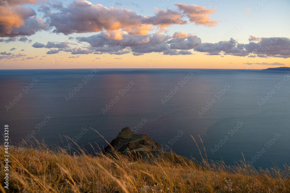 Stunning landscape on top of a mountain in the rays of sunset. Amazing view of the mountains and the sea coast, the concept of travel, freedom Stunning landscape on top of a mountain in the rays of sunset. Amazing view of the mountains and the sea coast, the concept of travel, freedom