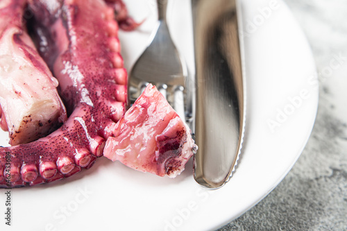 octopus food in a plate seafood second course fresh ready to eat meal snack on the table copy space food background rustic. top view keto or paleo vegetarian food no meat pescetarian diet photo