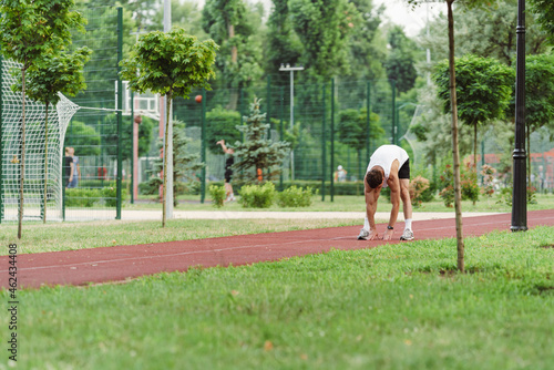 Young white runner working out on playground outdoors