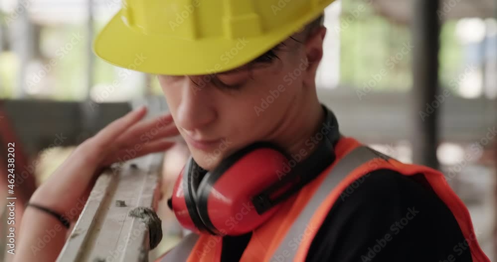 Confident people working in construction site. Portrait of happy hispanic man at work in new house inside apartment building. Professional worker lifting ladder and smiling at camera. Slow motion Confident people working in construction site. Portrait of happy hispanic man at work in new house inside apartment building. Professional worker lifting ladder and smiling at camera. Slow motion