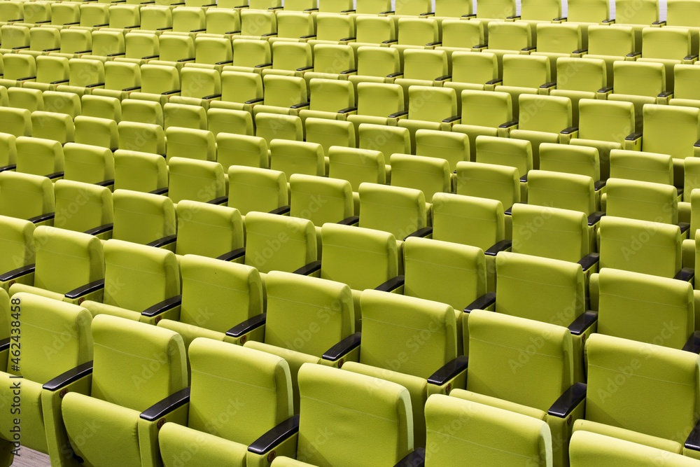 rows of green seats in a theatre rows of green seats in a theatre