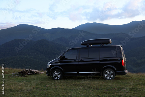 Black van parked in clearing among mountains © New Africa