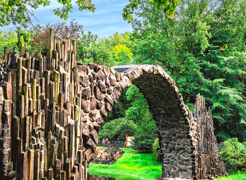 Rakotz Bridge, Rakotzbrucke in Kromlau, Saxony, Germany. Fantastic landscape in Azalea and Rhododendron Park Kromlau. Reflection of bridge in water of Rakotzsee. traveling and travel goals for tourism photo