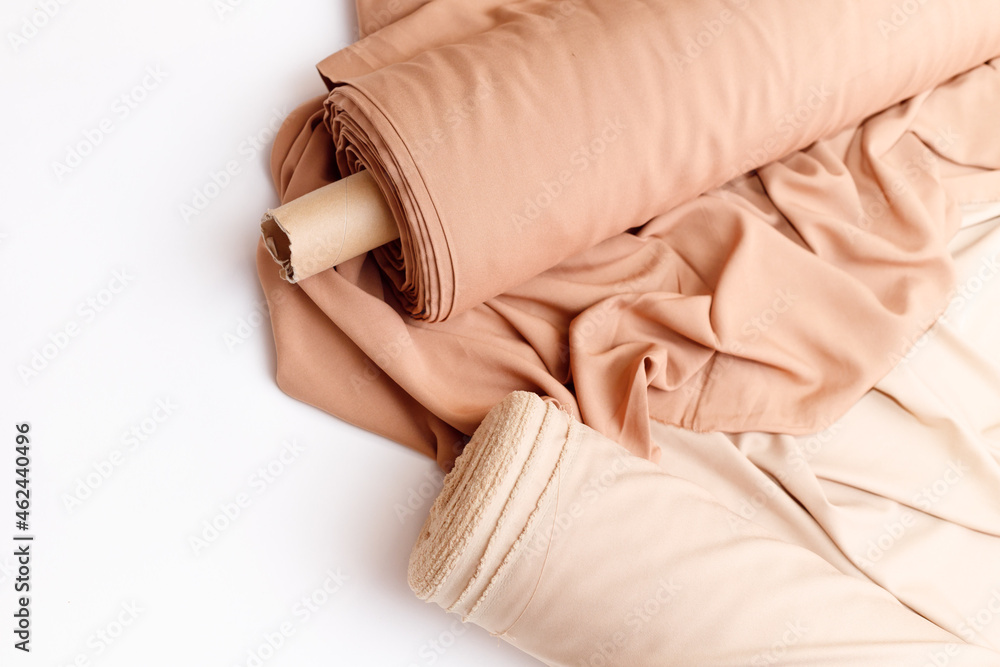 Rolls of pastel color fabric isolated on white