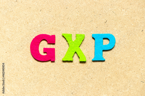 Color cloth alphabet letter in word GXP on wood background