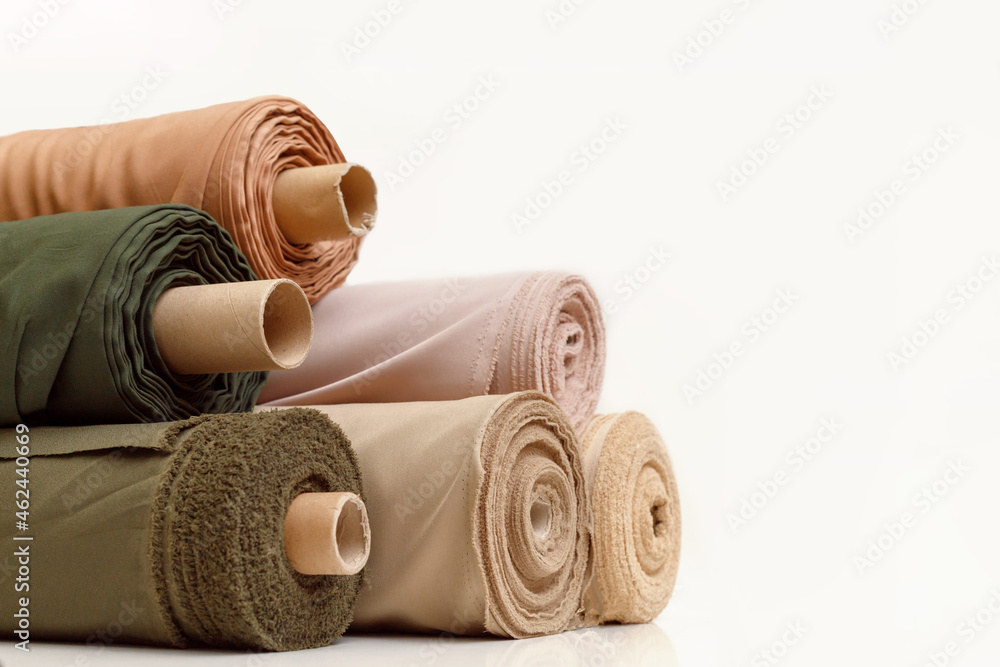 Rolls of pastel color fabric isolated on white