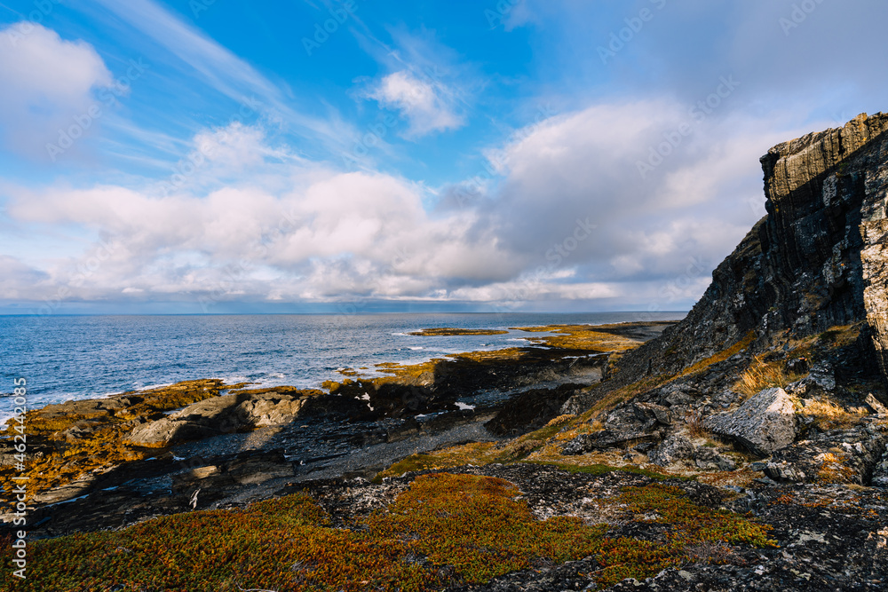 Rocky coastline of the Barents Sea. Autumn landscape. Beautiful views of the rocks, autumn tundra  and coast.  Rybachy Peninsula, Murmansk Oblast, Russia.