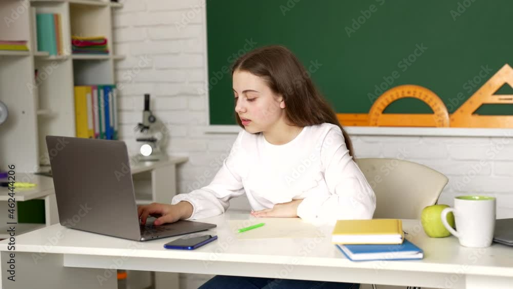 Girl pupil got anxious after using laptop computer and take mobile phone at lesson, study Girl pupil got anxious after using laptop computer and take mobile phone at lesson, study