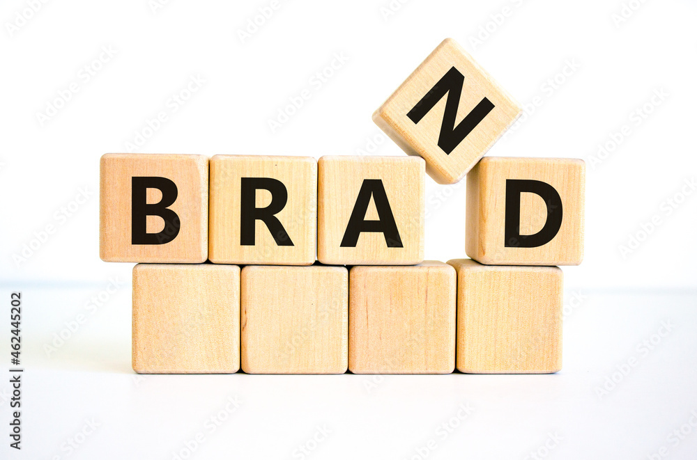 Brand symbol. The concept word 'brand' on wooden cubes on a beautiful white table, white background. Business and brand concept. Copy space. Brand symbol. The concept word 'brand' on wooden cubes on a beautiful white table, white background. Business and brand concept. Copy space.