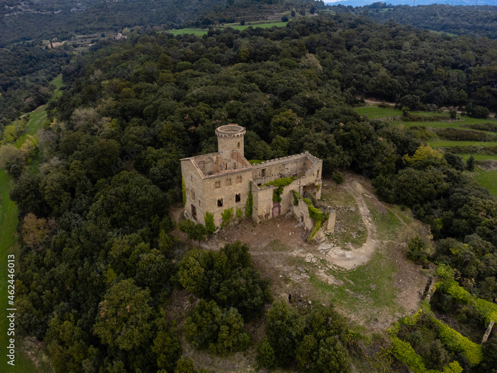 aerial view with drone of castell de clascar in the middle of the forest and cloudy day puiggracios catalonia spain