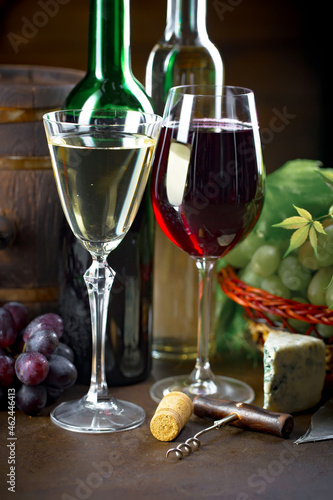 Wine glass with bottle and grapes on an old background.