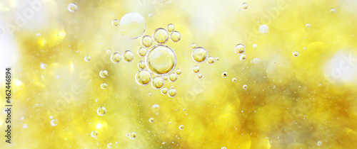 Gold Oil bubbles close up. circles of water macro. abstract shiny yellow background. banner