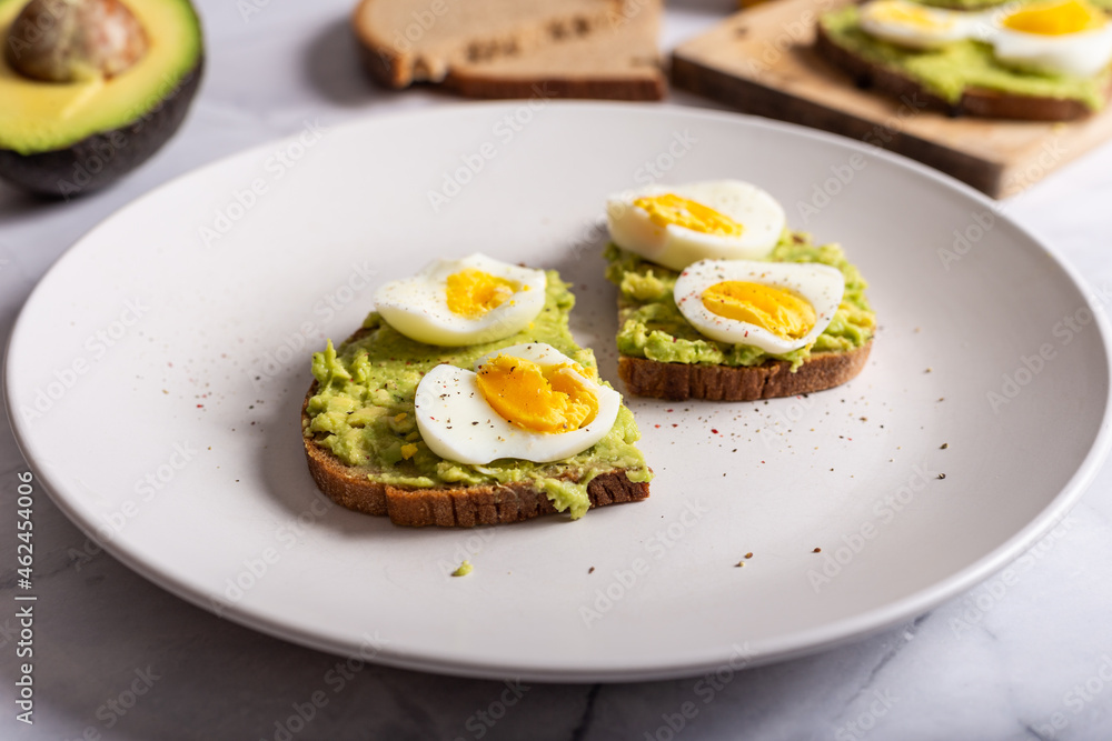 Avocado toast with eggs. Healthy snack and lunch. Ideal for a vegetarian diet. Avocado toast with eggs. Healthy snack and lunch. Ideal for a vegetarian diet.
