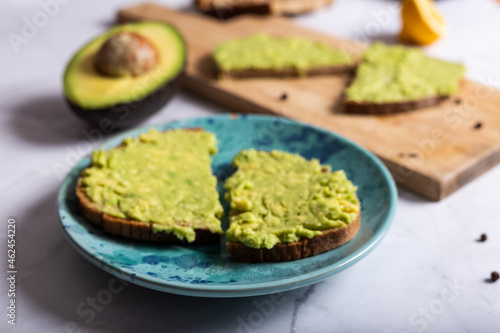 Bread with avocado, on a white background healthy snack.CR2 © Noemi