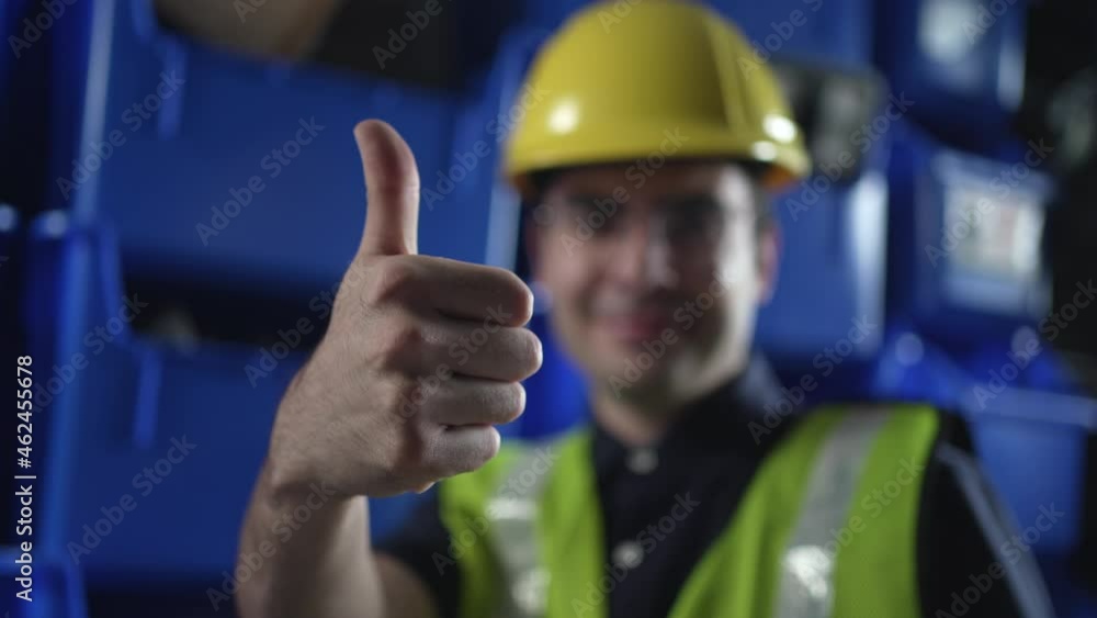 Warehouse Worker With Hard Hat Giving a Thumbs Up Closeup Warehouse Worker With Hard Hat Giving a Thumbs Up Closeup
