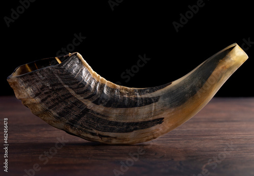 A Shofar Rams Horn on a Dark Wooden Table