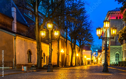 Sparkling street lamps in old town square at night