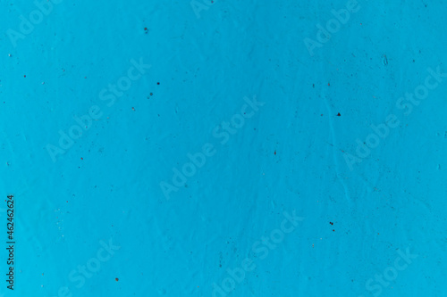 Blue paint on the wall.Rough uneven surface. © Cherkasova Alie
