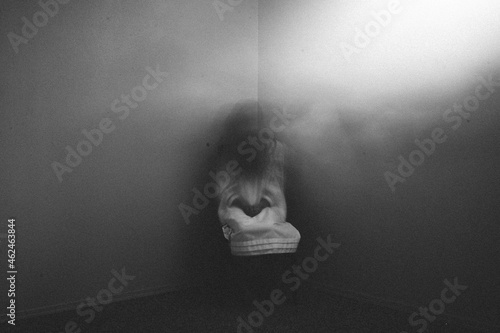 Ghost girl sitting in dark foggy corner of haunted house