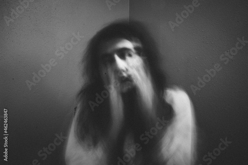 Portrait of spooky girl against wall at home