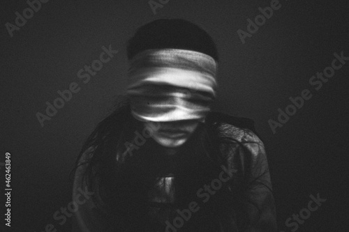 Portrait of creepy girl with bandages over her eyes photo