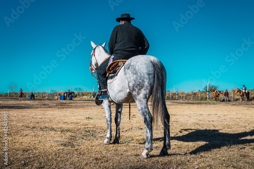 Argentine gaucho with hat on horse photo