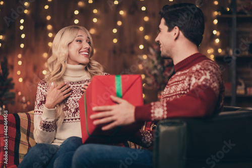 Photo of adorable impressed wife husband dressed print pullovers getting christmas greetings smiling indoors room home house
